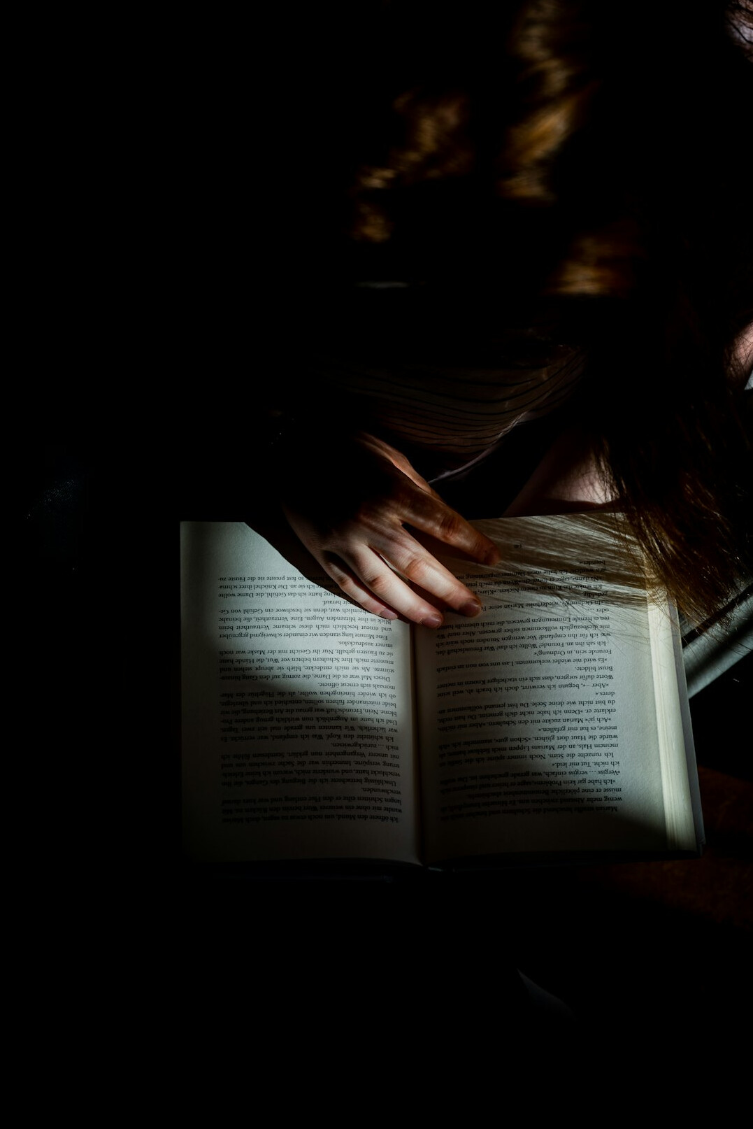 person reading book at night