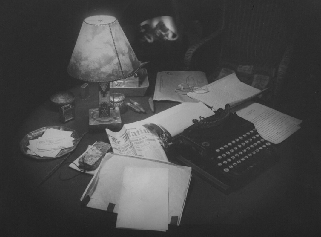 thriller writer at desk with notes